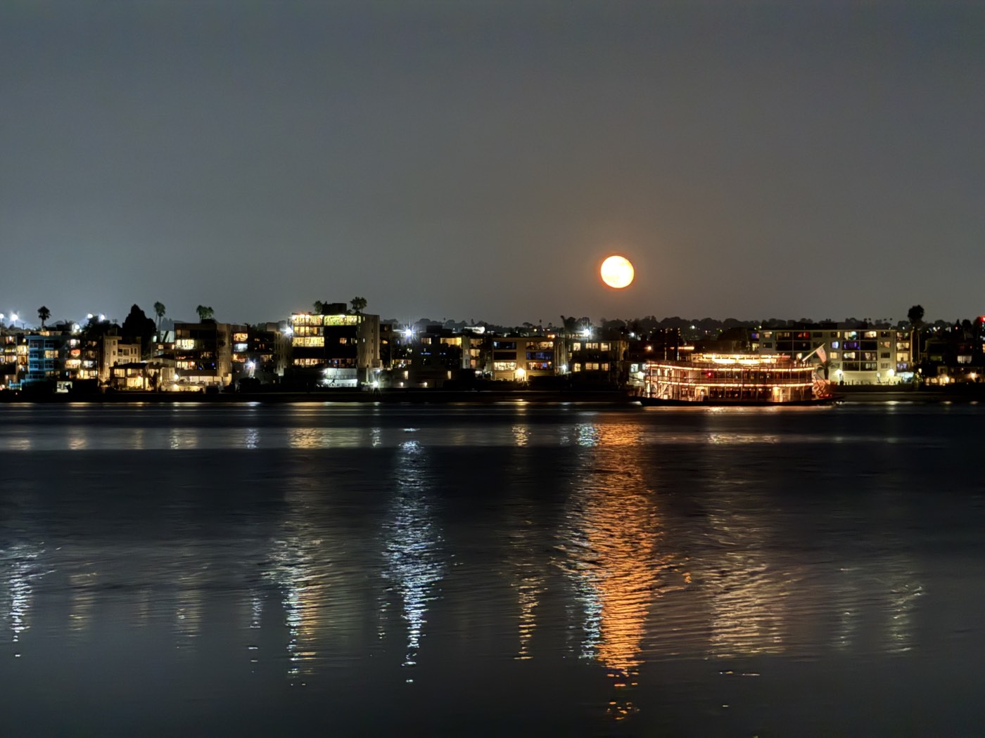 The moon rising over Mission Bay, reflected on the water